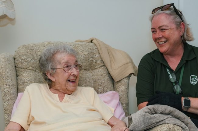 Meals on wheels driver with client