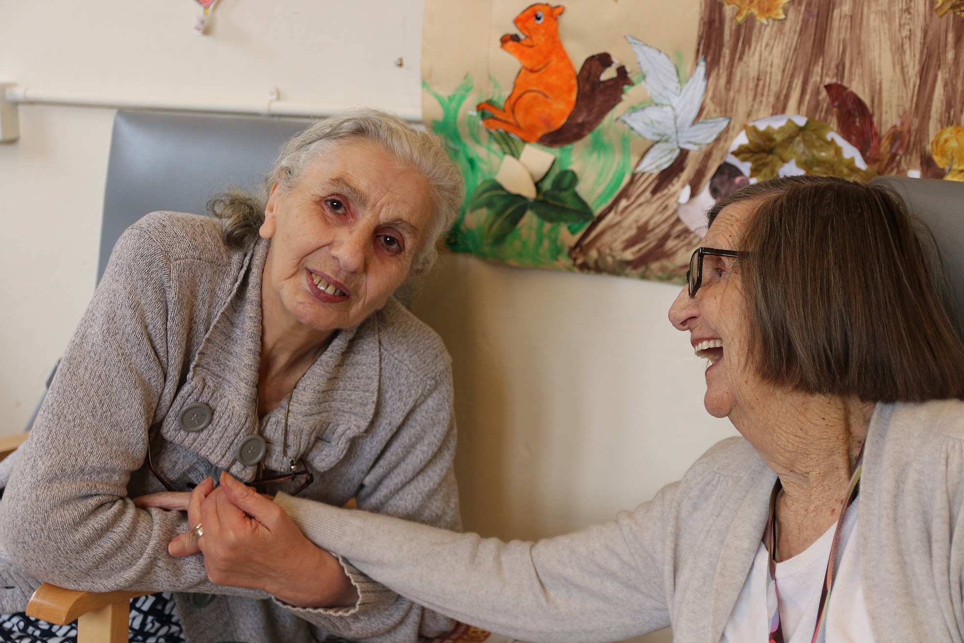 Two dementia club clients smiling and interacting