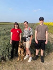 Rachel, HILS Community Advocate with her dog and children enjoying some down time